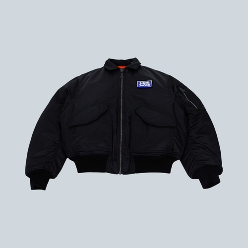 Blouson bomber noir Saison x Schott style années 90 avec fermeture éclair robuste, col et poignets côtelés