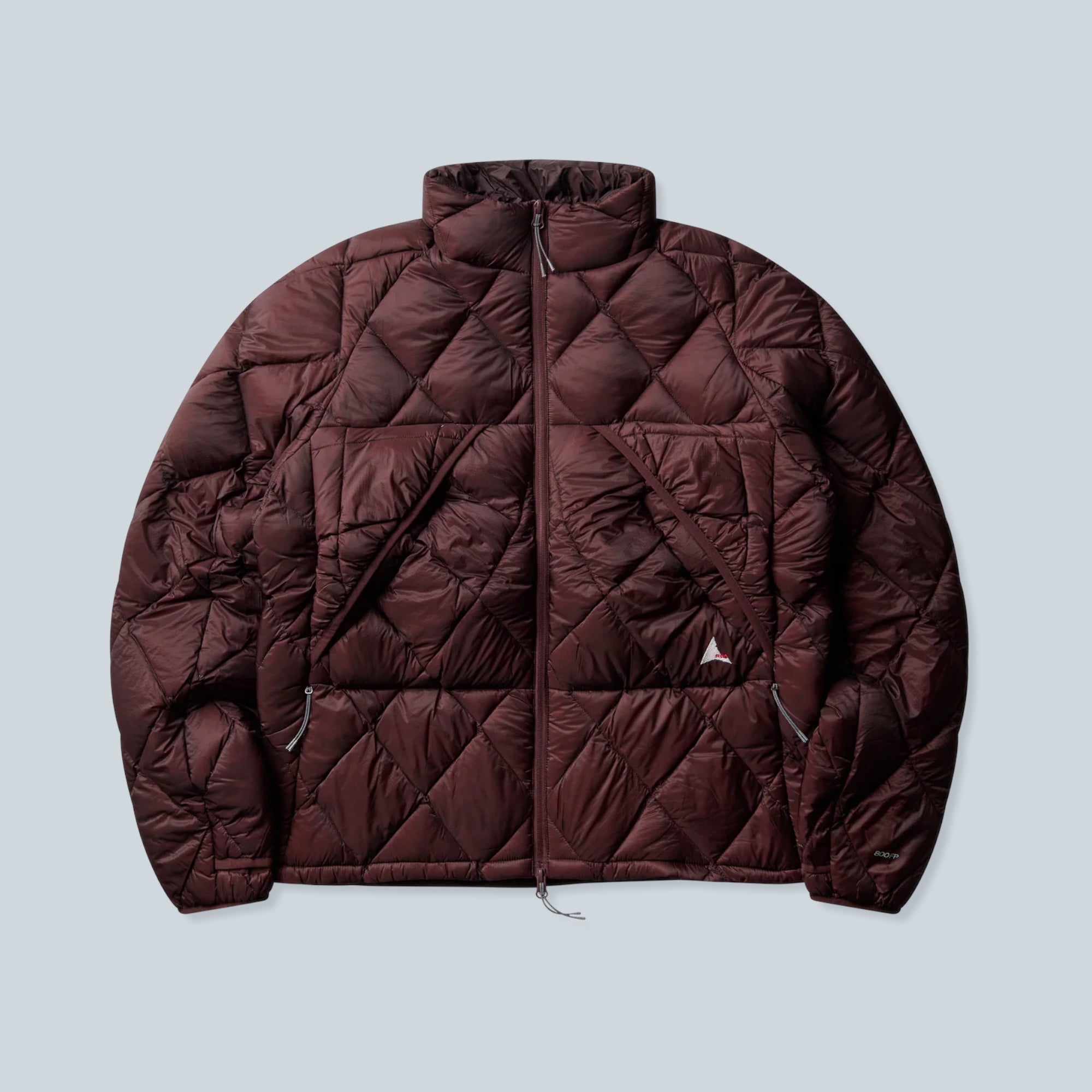 Doudoune Saison Nuna bordeaux en nylon avec matelassage en losanges, fermeture zippée et garnissage en duvet de canard