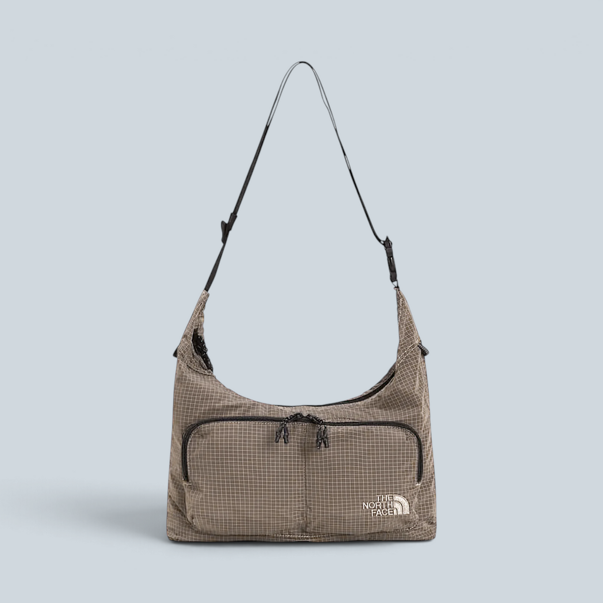 Sac bandoulière Saison Never Stop en tissu quadrillé couleur garnet avec fermeture zippée et logo The North Face