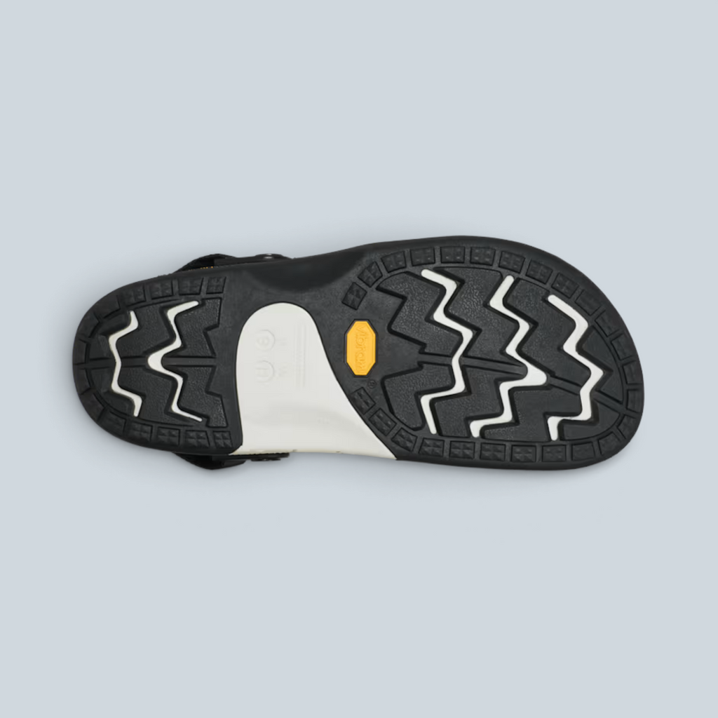 Semelle extérieure noire et blanche de sabot Saison avec crampons antidérapants Vibram et logo jaune