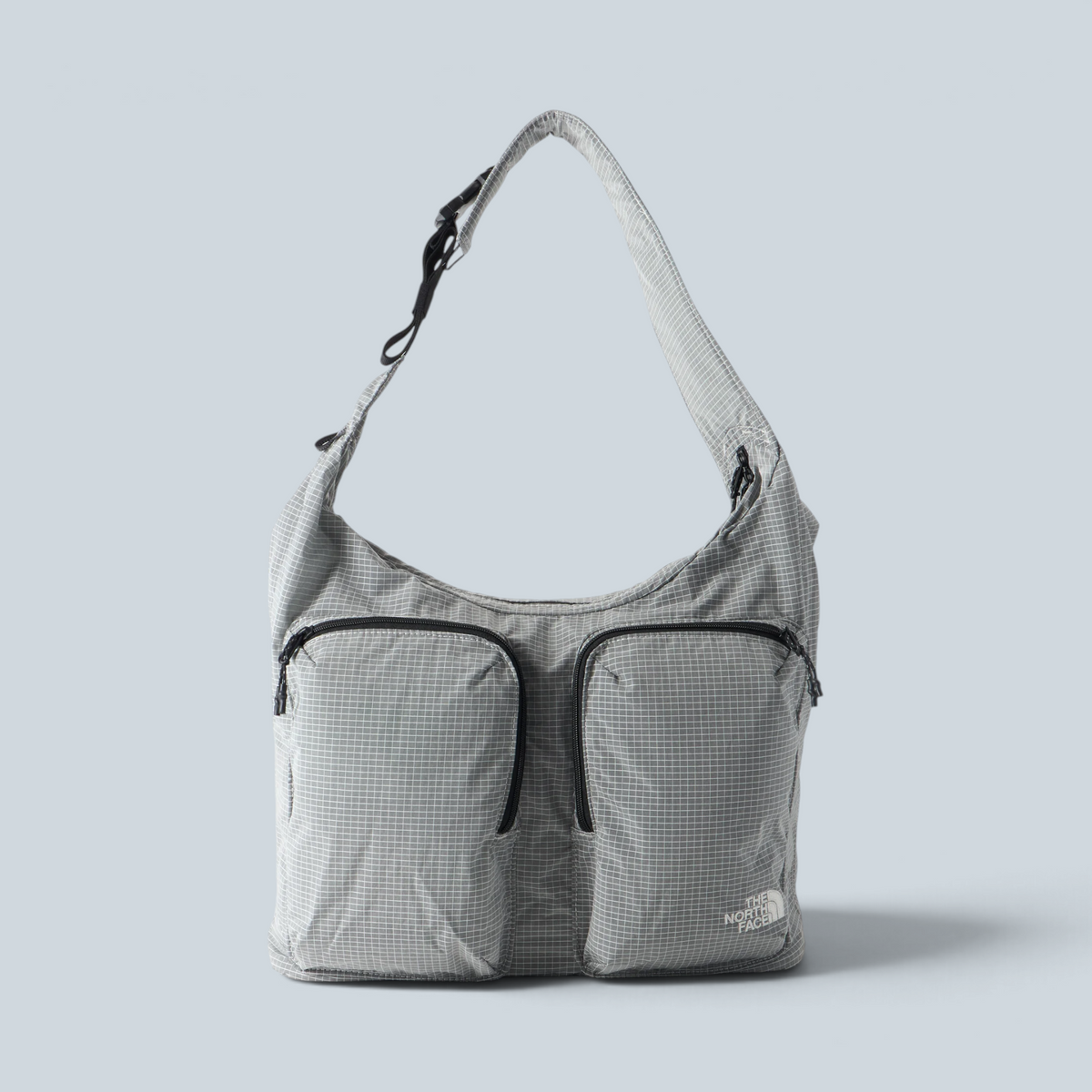 Sac cabas Saison The North Face Never Stop gris à motif quadrillé avec deux poches frontales zippées
