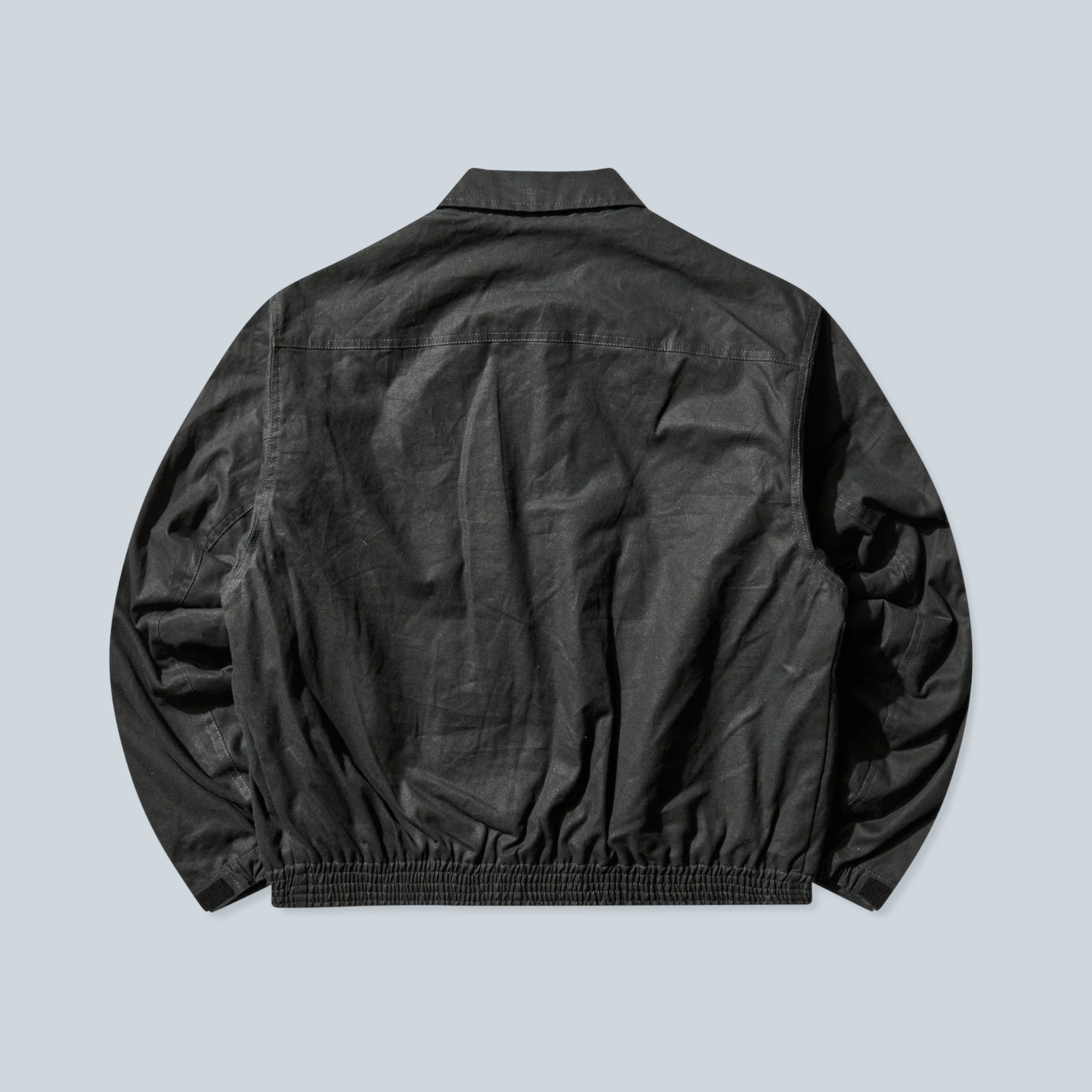 Vue arrière de la veste Saison Pilot en toile cirée vert foncé avec ourlet élastique et coupe workwear