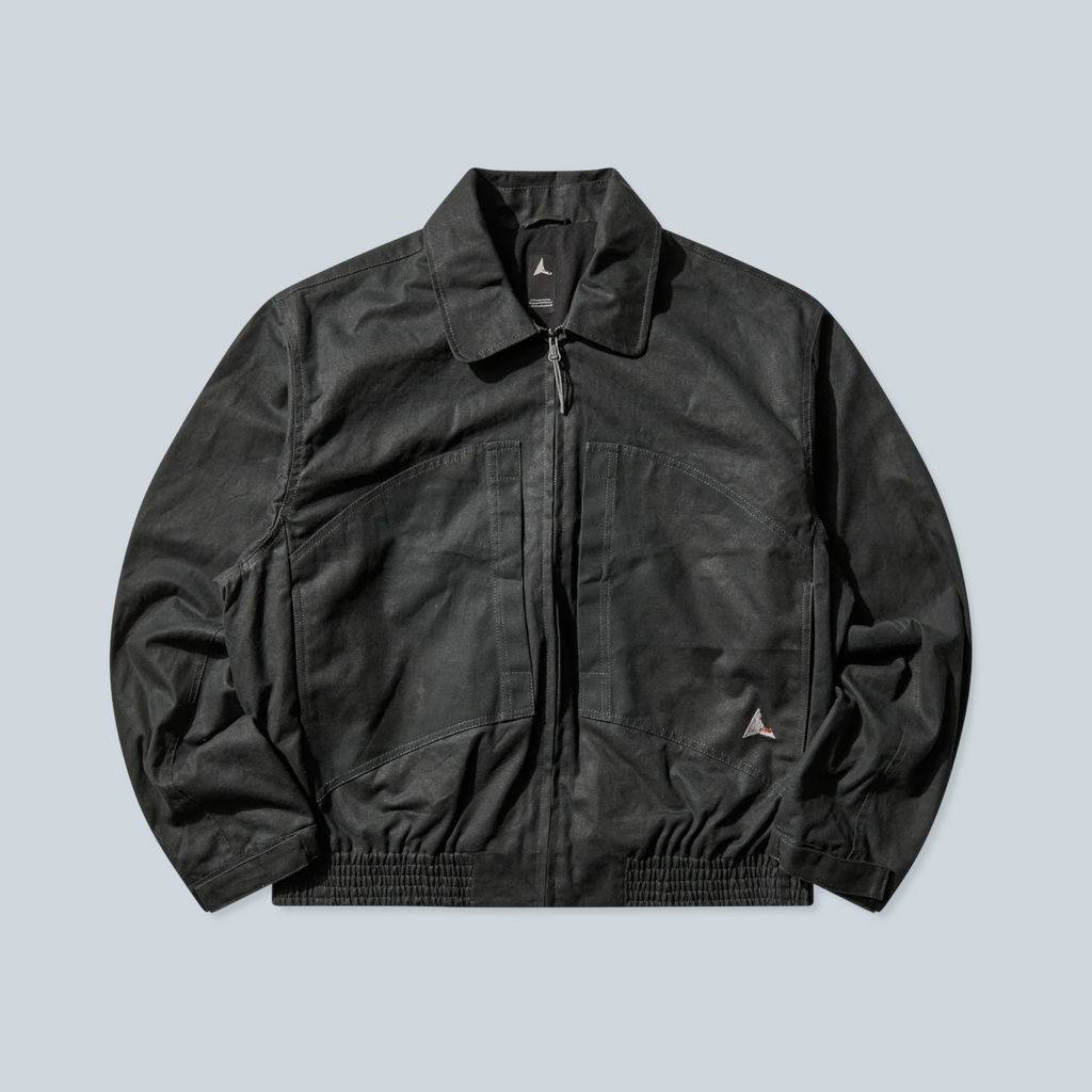 Veste Saison Pilot en toile cirée vert foncé avec coupe workwear, col classique et fermeture zippée