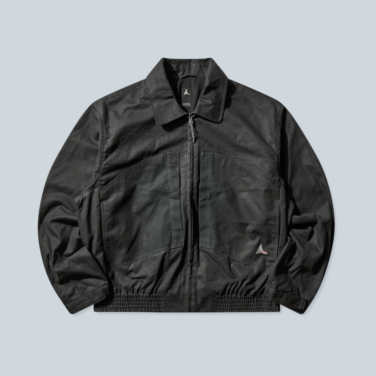 Veste Saison Pilot en toile cirée vert foncé avec coupe workwear, col classique et fermeture zippée